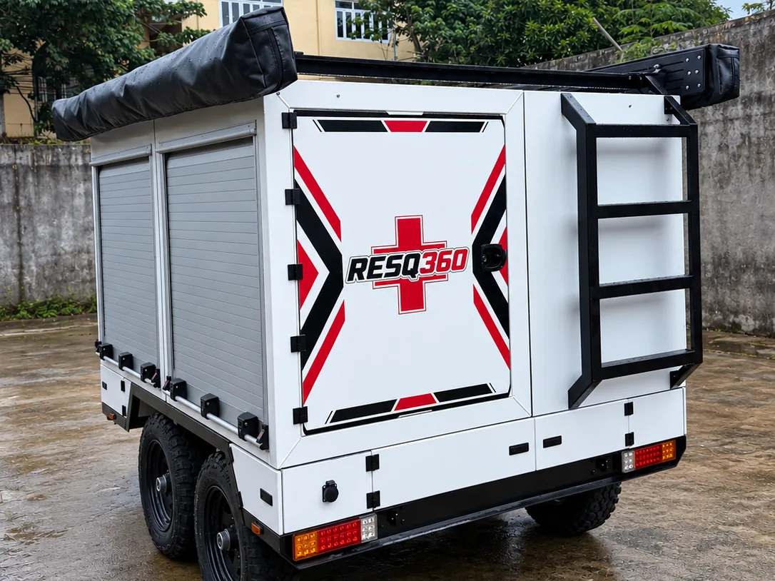 Rear three-quarter view of the Ironwolf Rapid Rescue Platform, showing roller-shutter equipment lockers, access ladder, rear light clusters and tandem axles